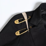 Jacket adorned with golden pins